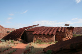 The original name of the farm, in Afrikaans, was Twyfelfontein or "Doubtful Fountain." The prior owner was known for fearing his spring would go dry. The building in the photograph is not of the original farm but rather the rock engravings historical center and guide headquarters.