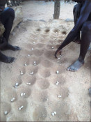 The African Stone Game (sometimes called Awari or Mancala) is a two-player game in which each player tries to capture more stones than the other before all the pits on either side of the board are emptied.