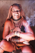 The Himba wear little clothing, but the women are famous for covering themselves with otjize, a mixture of butter fat and ochre, possibly to protect themselves from the sun. The mixture gives their skins a reddish tinge.