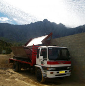 A flatbed truck has been positioned to take on gondola loads of harvested grapes. Silkbush purchased hydraulic grape containers for trucks which hold about 8-9 tons of grapes; the hydraulic gondolas, which haul at least three tons of grapes, will be pulled onto the loading ramp by tractors. Three gondola loads go onto each truck, and then Anton or his assistant will drive the truck to the winery.