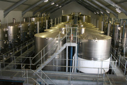 Most stainless steel tanks look about the same, but there are some clever design ideas incorporated in this winery. The large tanks in the center are self evident, but on the sides there are two rows of smaller tanks, one stacked on top of the other. Many times wineries need smaller tanks but they often take up the same building "footprint" as larger tanks, forfeiting the volume above. By stacking tanks, you do not require an excessively large winery building and still retain the ability of doing smaller fermentation lots.