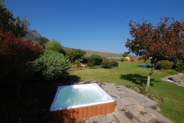 Another Kingsbury Cottage amenity is this large garden hot tub.