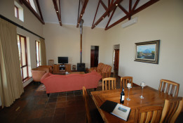 This photo shows the cozy dining and living area of our cute cottage.