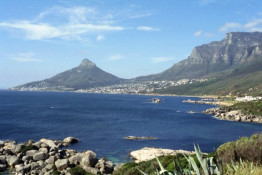 Two of the more fashionable communities south of Cape Town are Hout Bay, seen below the gap in the mountains, and Llandudno. Dave Jefferson, SILKBUSH Managing Director, was a luncheon guest of Mario Ilotte, a retired Italian Grand Prix race car driver, who lives with his wife and two sons in Llandudno. Mario and Christina elected to leave Milan in 1995 and emigrate to Cape Town because it represented a far better living condition for their family than Europe. They take their old Land Rover and frequently tour the "outback" of many of the countries to the north. Hout Bay (Houtbaai in Afrikaans) means "Wood Bay." It is near Cape Town, situated in a valley on the Atlantic seaboard of the Cape Peninsula. The name "Hout Bay" can refer to the town, the bay on which it is situated, or the entire valley. Llandudno is a residential suburb of Cape Town, also on the Atlantic seaboard of the Cape Peninsula. There are no street lights, shops or commercial activities, and the suburb has some of the most expensive residential property in South Africa.