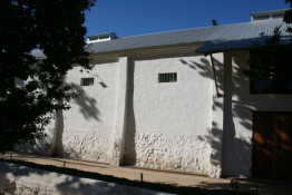 The external buttresses, the chest-high fieldstone foundation covered with rough plaster, and small, high windows at Kleinood all are indicative of wonderful respect of a bygone era. The grey steel roof is modern, of course, but all else evokes traditional Cape Dutch agriculture, especially the "ringmuur, the low brick wall defining a farmstead's former boundary.   But no, the sly architect and Libby, his designer wife, did this all from scratch in 2004! Bravo for a wonderful deception. Inside, the 6,300 case winery is very modern, stainless steel running everywhere, including a circular ceiling-mounted conveyor system which mechanically hoists and transports small tanks of fruit from destemmer to crusher to stainless steel open-top fermenters. More can be learned at  (<a href="http://www.kleinood.com">www.kleinood.com</a>) .