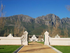 On the hill above his new winery Quoin Rock, Dave King built this Cape Dutch bungalow with magnificent views of Table Mountain. But, in 2006, the Republic of South Africa Receiver of Revenue's Scorpion fraud unit went after Mr. King for several billion Rand of unpaid taxes. A sale of Quoin Rock occurred in 2012. There has since been an exciting time of renewal and growth at Quoin Rock. They recently completed a full refurbishment of the cellars, doubling capacity in some areas, and with a variety of new technology which will offer great flexibility in the creation of the wines. For the 2014 harvest, their viticulturist, Nico Walters, has been using micro-management techniques to ensure the best possible quality, health and optimal ripeness of the grapes to be delivered to the cellar. And, with this process now running smoothly, winemaker, Narina Cloete, will get a head start in the new state-of-the-art cellar, where the range of innovative new winemaking equipment will help her to lead the industry in producing balanced wines that will age beautifully.