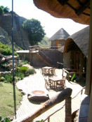 This photo shows more of the external traditional design of the 12-guestroom lodge. The lodge is built onto a steep iNyoni cliff on which the commander of the Zulu army directed his warriors' attack. The British were invading Zululand and did not know the territory well enough, or sufficiently respect their opponent.